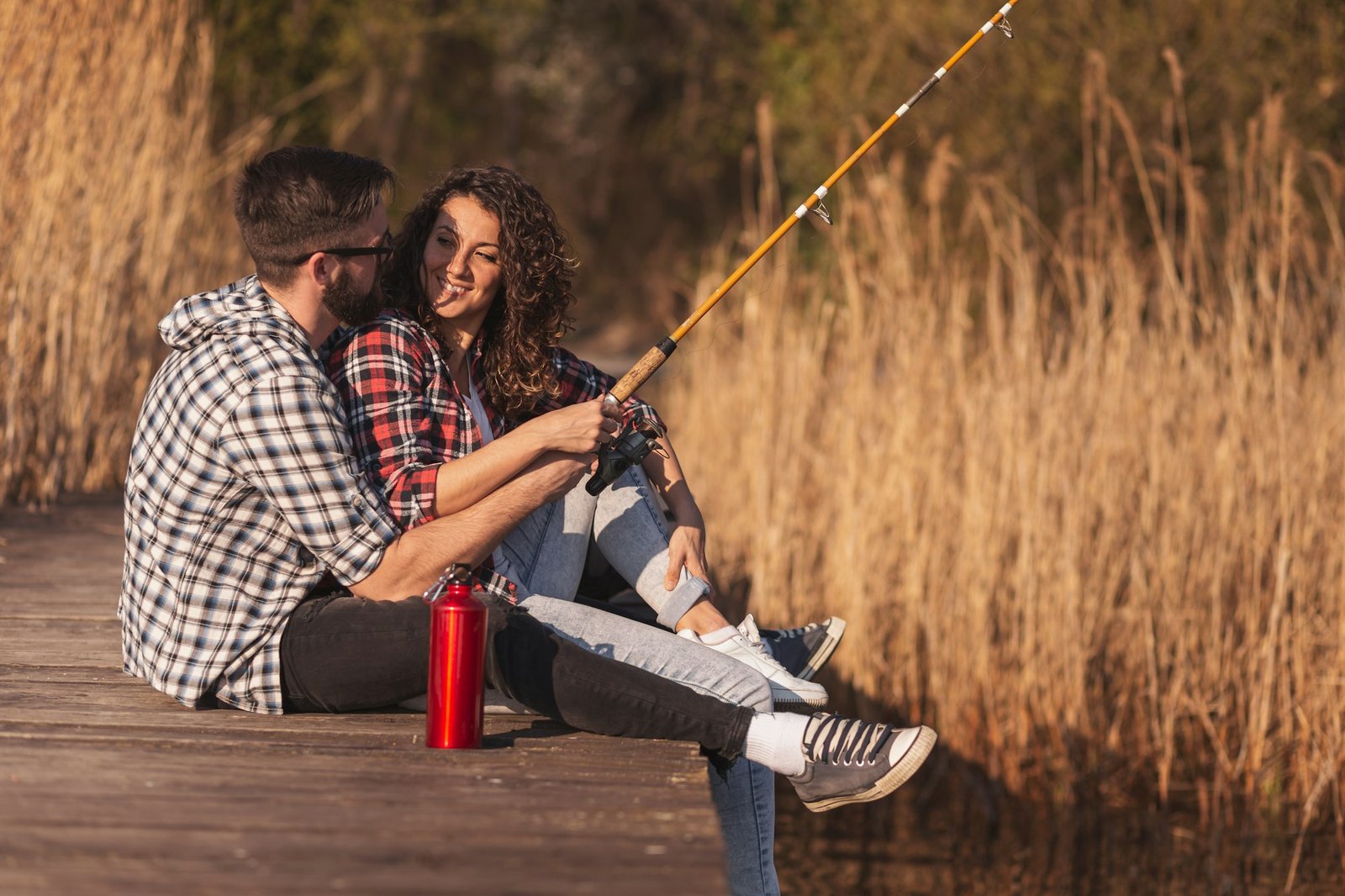 Couple fishing at lake docks