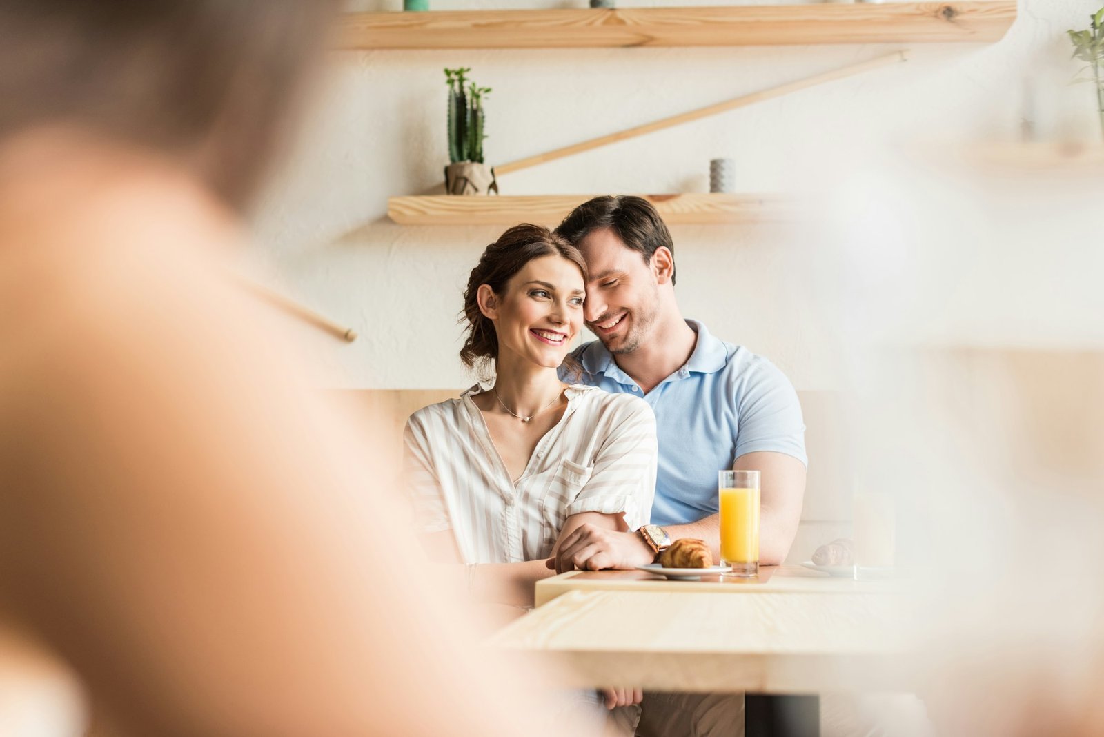 smiling young couple dating in cafe